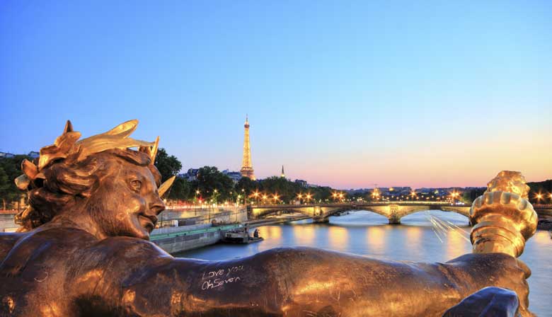 The Seine river and the Alexandre III bridge illuminated
