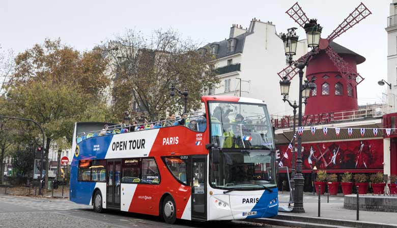 The Opentour bus in front of the Moulin Rouge